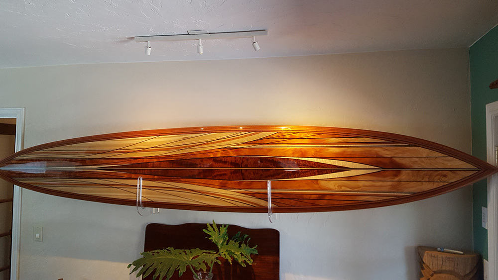 michael rumsey wood surfboard titled viking made with koa wood, redwood, natural colors from reclaimed lumber