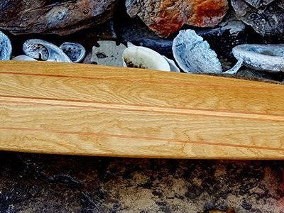 A wooden skateboard with orange wheels