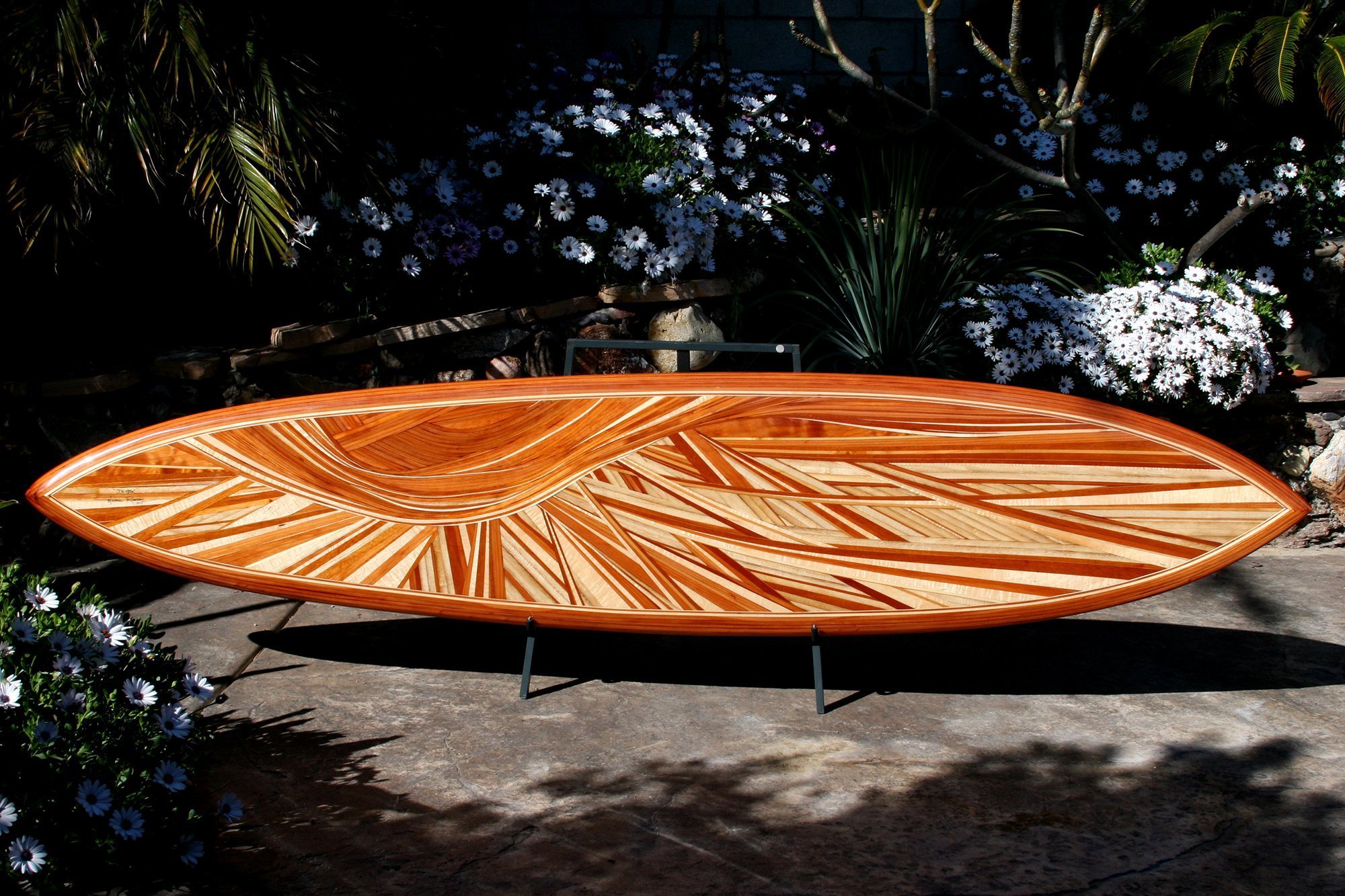 decorative surfboard titled da hook built by mike rumsey who used a variety of lumber species void of paint or stain